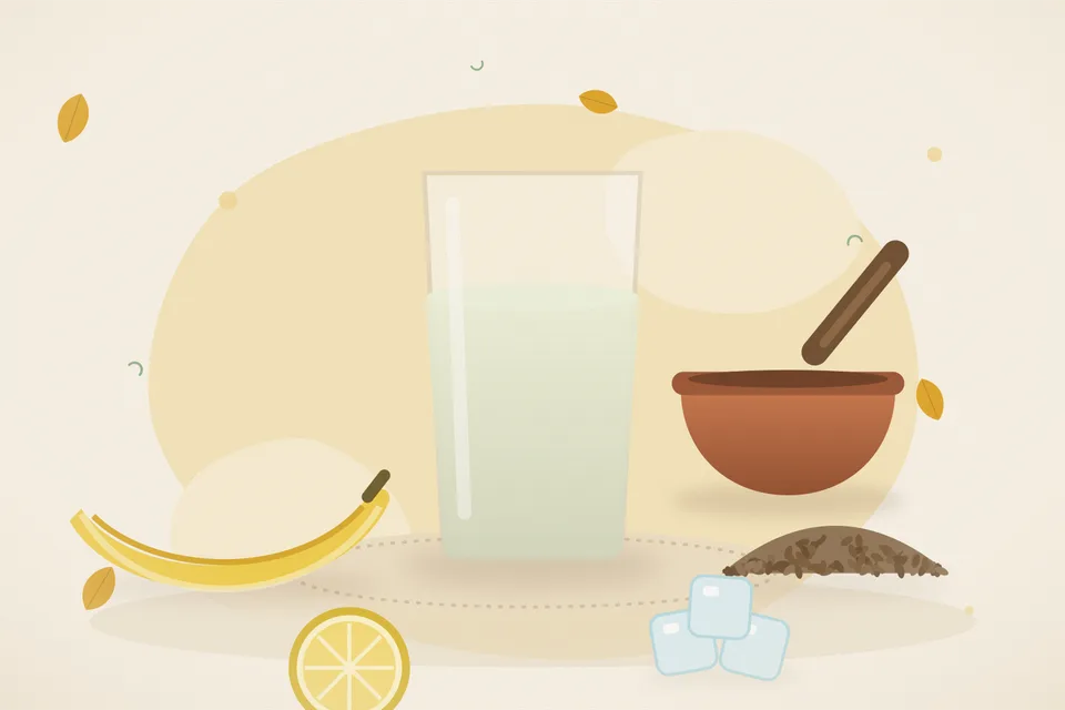 A cut banana stem, cumin seeds, a lemon wedge and a small glass of pale diluted juice on a steel plate