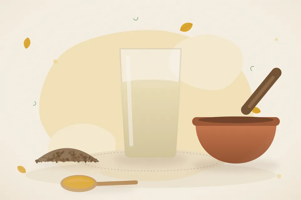 A bay leaf, cumin seeds and a brass cup of warm infusion on a wooden board