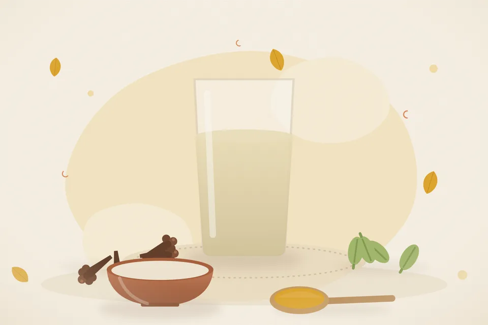 One clove and one green cardamom beside a small steel cup of clear spice water on an evening kitchen table.