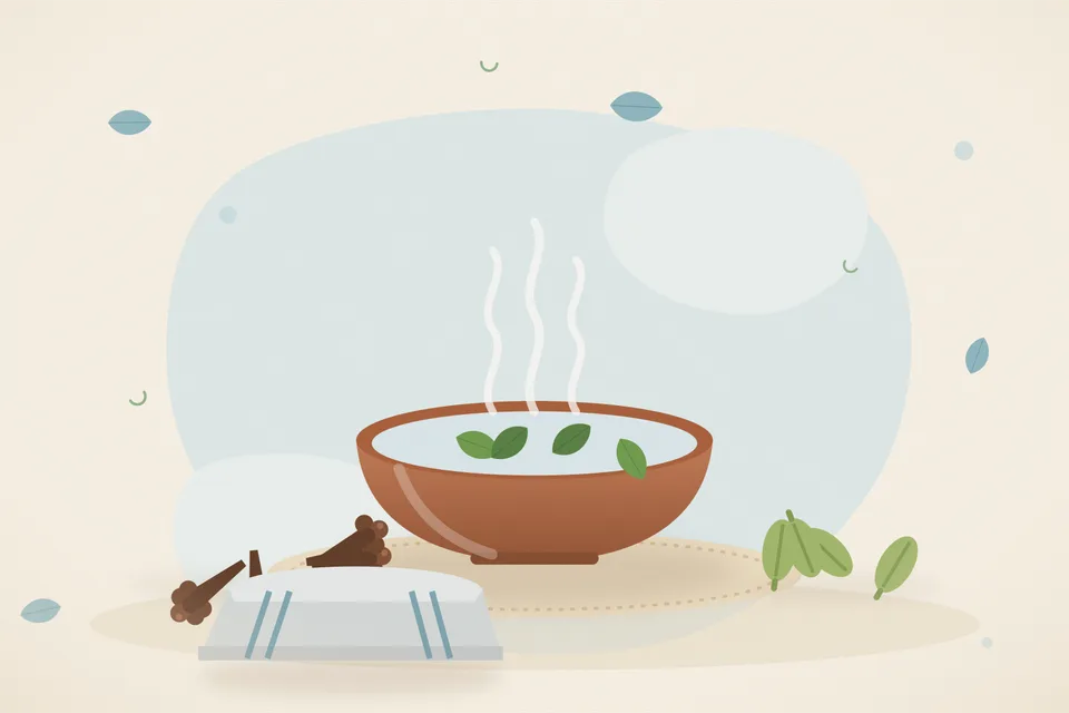 A stable kitchen bowl of hot water with one clove and one cardamom, and a folded cotton cloth beside it on a table.