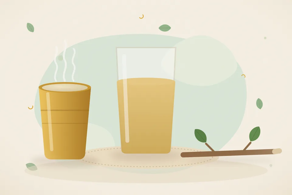 Tender green guava leaves in a small steel pot of water on a kitchen stove, with an empty cup beside the pot.