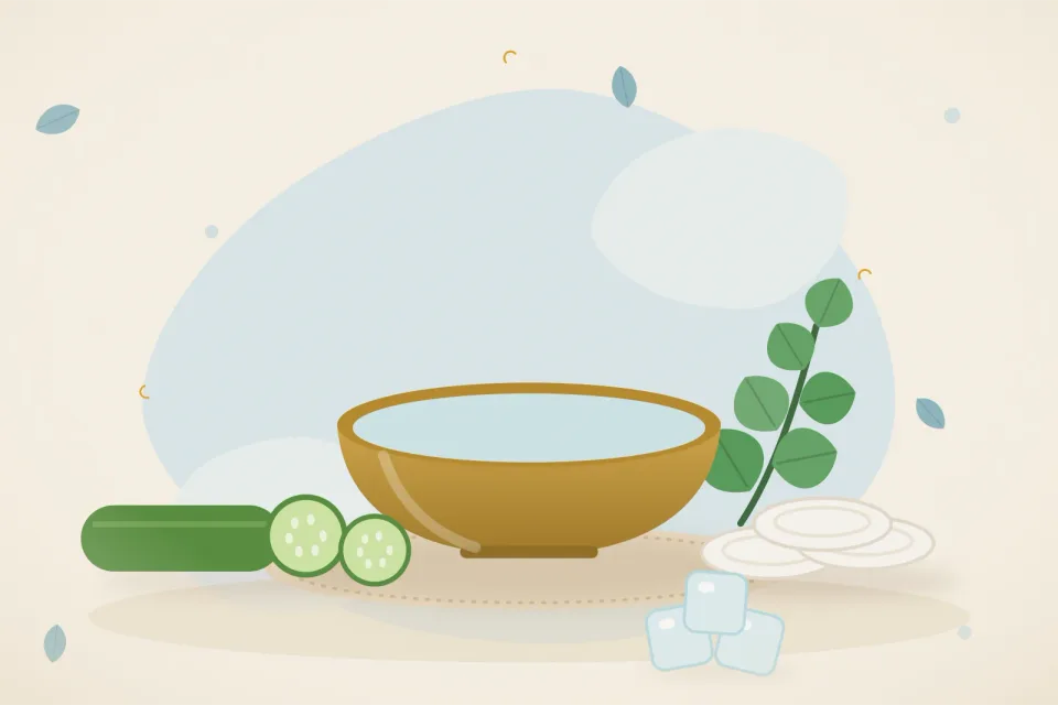 Bowl of cool water, ice cubes, cucumber slices and cotton pads on a light blue background