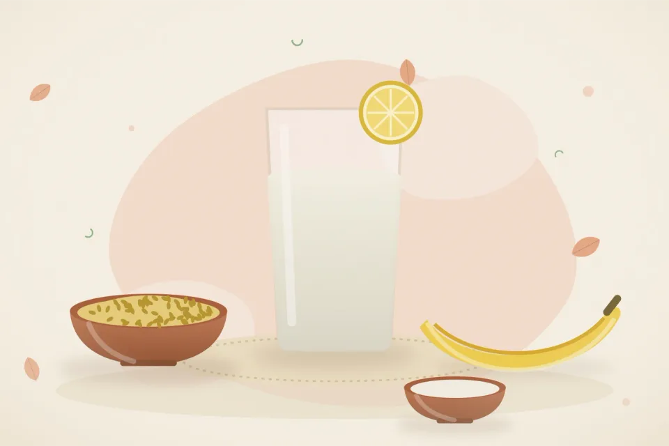 Glass of ORS with lemon, a bowl of khichdi, bananas and a small bowl of curd on a peach background
