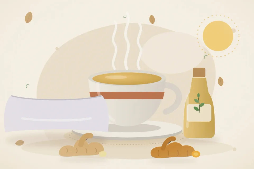 A cup of ginger-turmeric tea, fresh ginger and turmeric root, a bottle of sesame oil and a soft pillow on a sandy beige background