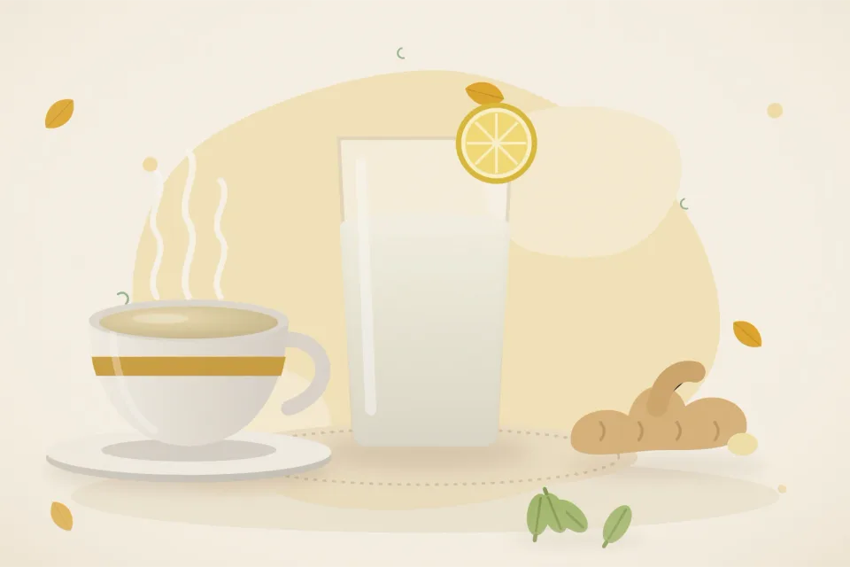 Glass of ORS with a lemon slice, a small cup of ginger water, fresh ginger root and green cardamom pods on a warm turmeric-yellow background