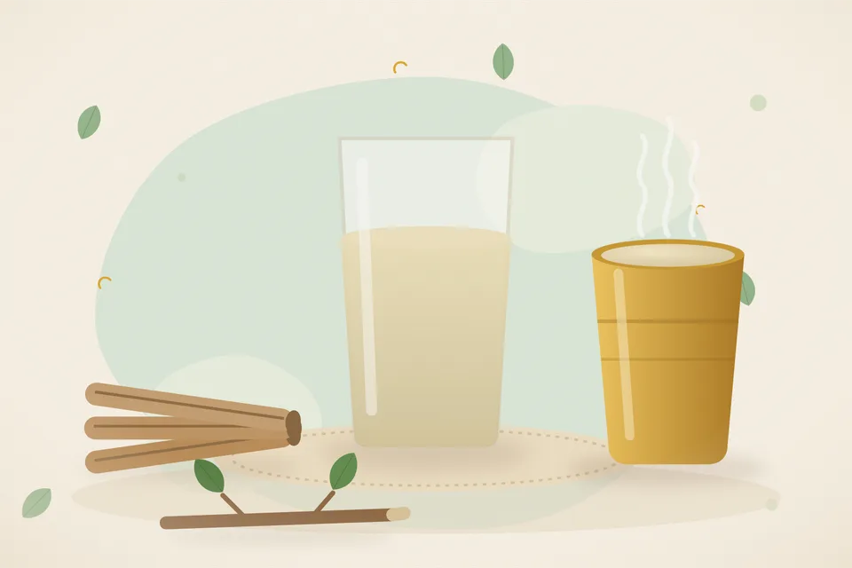 A tiny pile of pale mulethi powder on a ceramic spoon next to a glass of water on a kitchen counter.