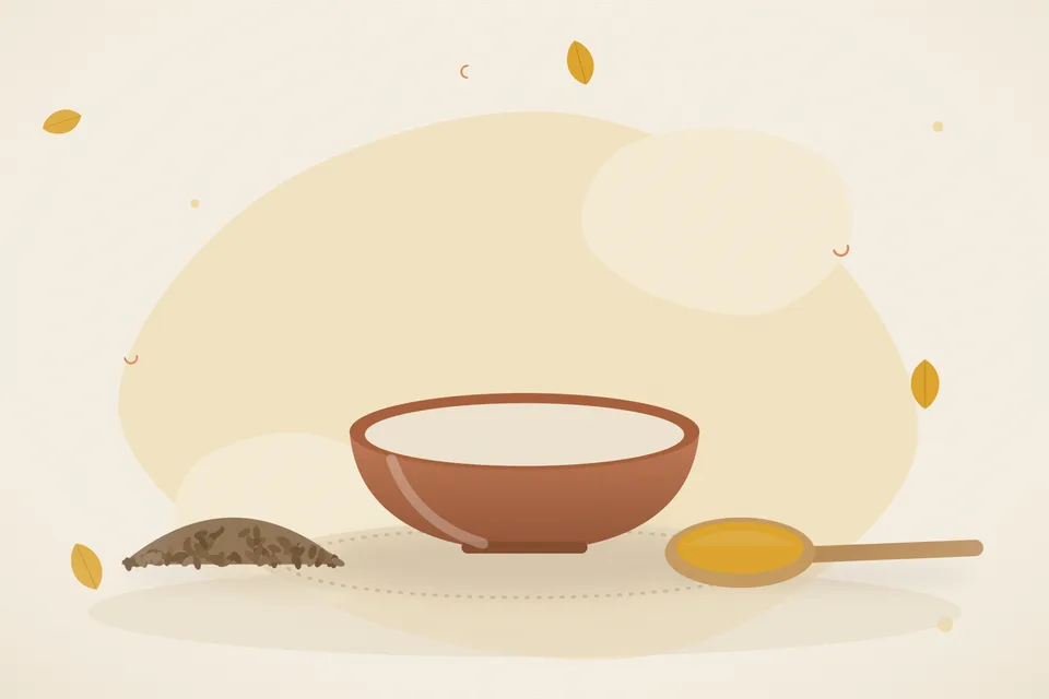 A handful of moringa leaves, cumin seeds and a small bowl of ghee on a wooden board