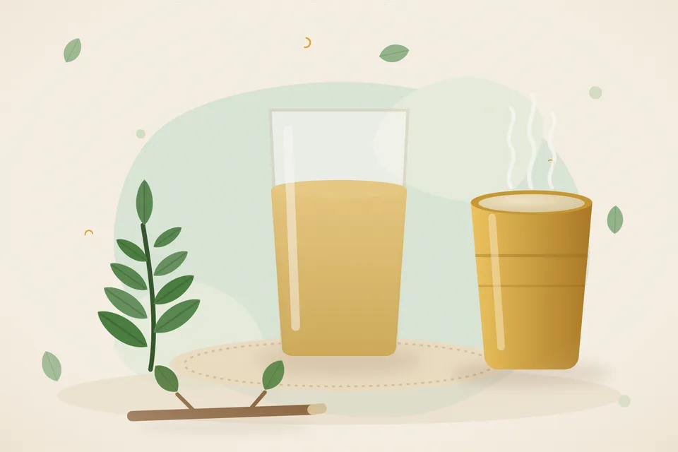 A handful of neem leaves in a steel saucepan of water on a kitchen stove, with a strainer and a cup beside it.
