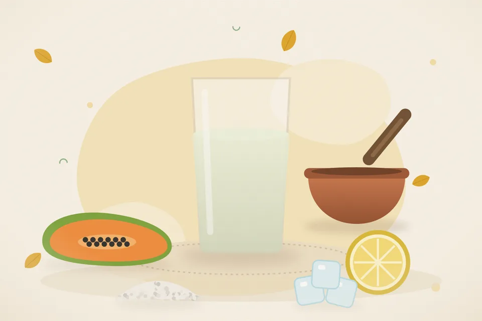 Cubes of ripe papaya, a lemon wedge and rock salt on a wooden board
