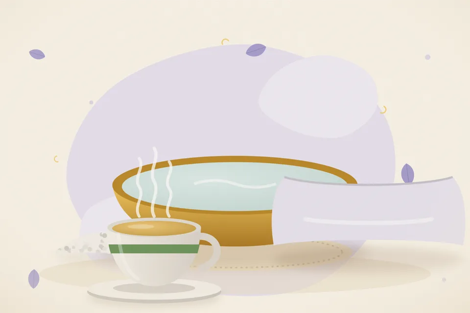 A wide steel basin of warm water beside a wooden bowl of rock salt crystals on a kitchen counter.