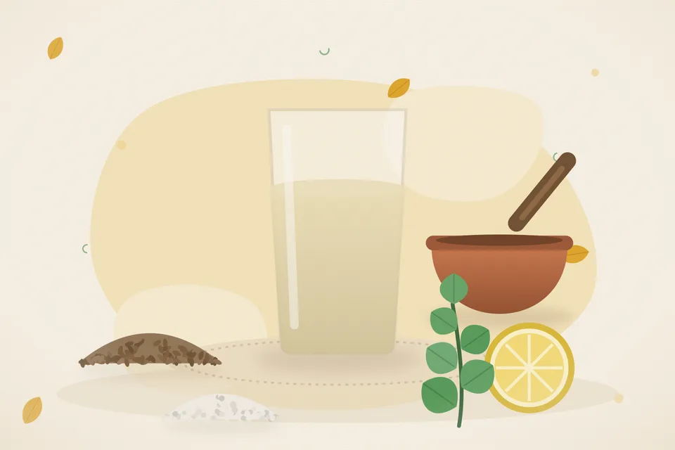 Sattu flour, cumin, lemon, rock salt and mint beside a glass on a wooden board