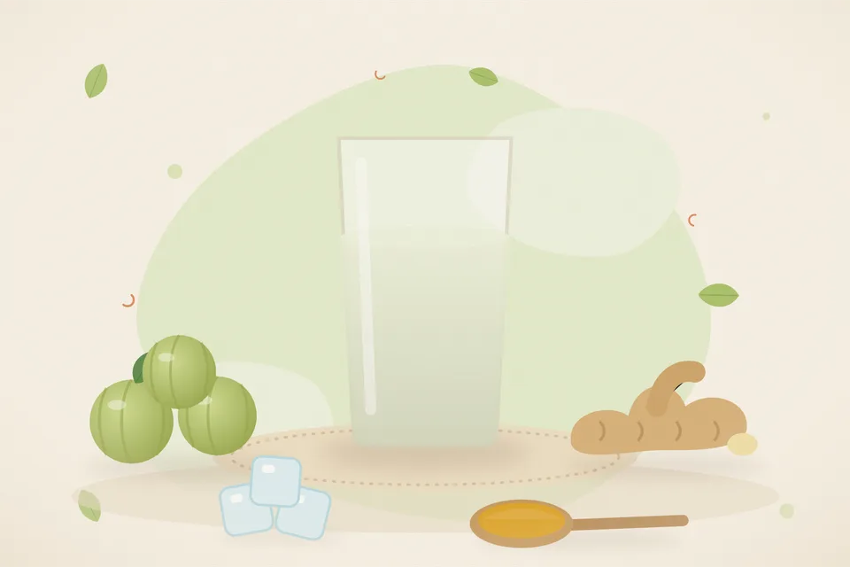 A small glass of cloudy diluted amla water beside a cut amla and a slice of ginger on a stone kitchen slab, no people and no lettering.