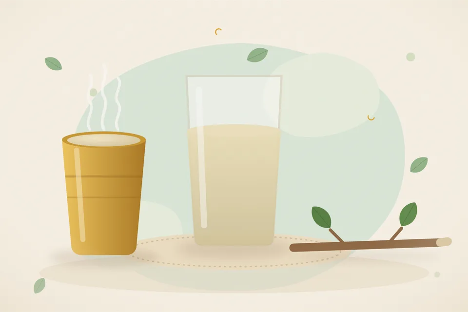 A pinch of brown triphala powder beside a glass of warm water and a small spoon on a kitchen counter.