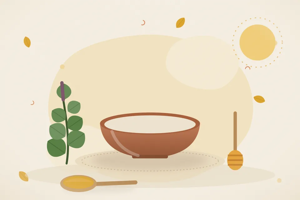 Three fresh tulsi leaves and a small brass bowl of honey on a wooden board