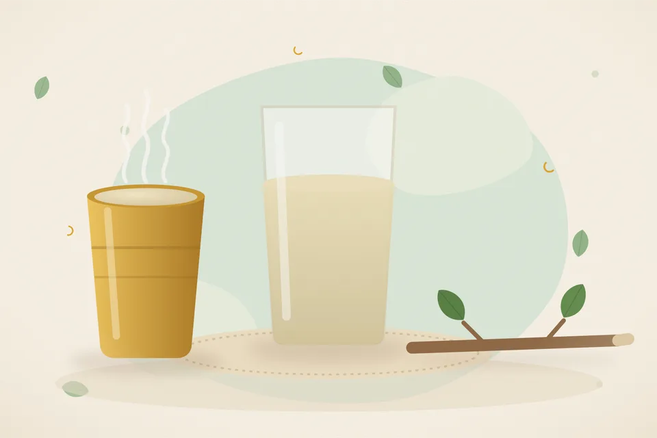 A clear glass of warm water with a tiny dish of salt and a teaspoon on a kitchen counter.