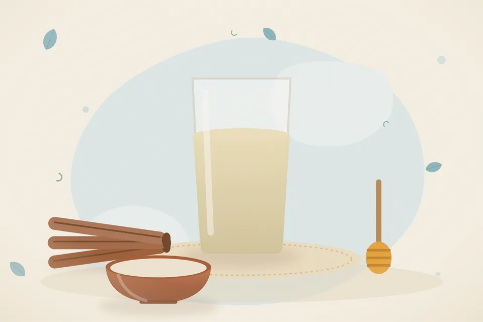 A bowl of plain cooked oats, a small cinnamon stick and a spoon on a wooden table, morning light, no honey jar, no people and no lettering.